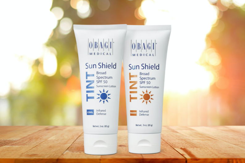 two sunscreen bottles on a table