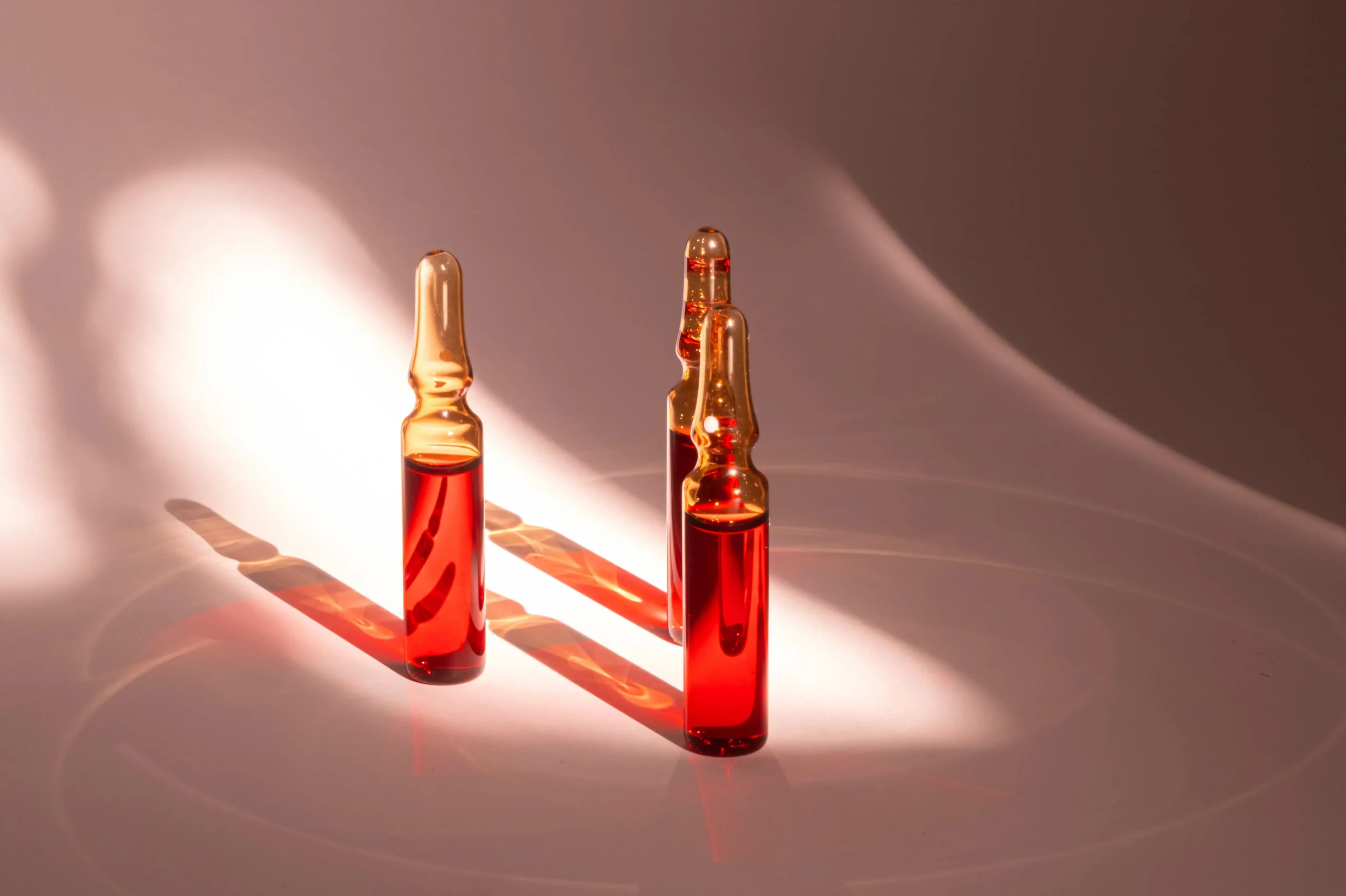a group of ampoules with red liquid