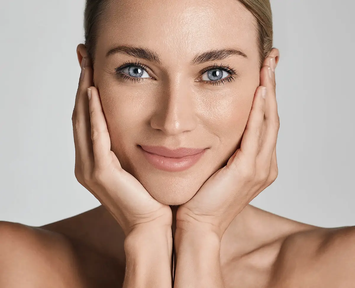 a woman with her hands on her face